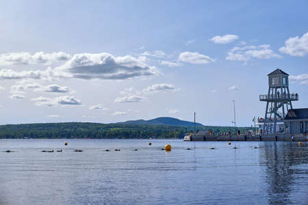 Magog, Quebec, Canada - September 8, 2018: Wharf and observatory tower in the evening on Memphremagog Lake in Magog, Province of Quebec, Canadaのeditorial素材