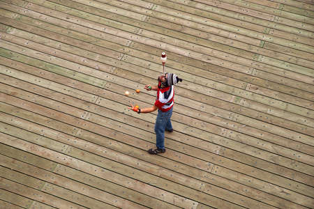 Quebec city, Canada september 23, 2018: A street performer juggling with balls while high up in...
