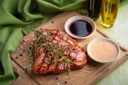 Grilled Florentine steak on a chopping Board. Cooked beef meat. White wooden background. Concept of healthy eating for menu.の写真素材