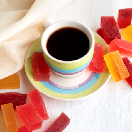 Close up cup of coffee with marmalade on the table. On white background.の写真素材
