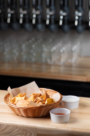 Nachos, corn chips on plate. Wooden background. Copy space. Menu for beer in restaurantの写真素材