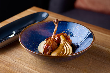 Exclusive restaurant meals. duck leg with apple and celery puree against table background, copy spaceの写真素材