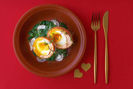Typical British dish Scotch egg. red background.