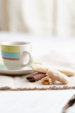 chocolate sticks in a bowl on a white background.