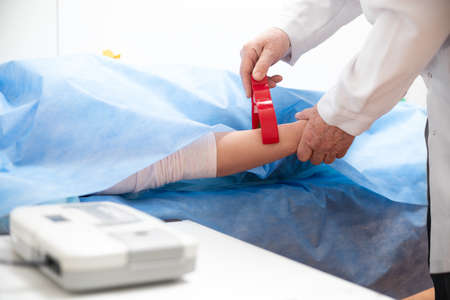 Doctor hands, Cardiotocograph device in a hospital to examine fetus heartbeat and make cardiogram.の写真素材