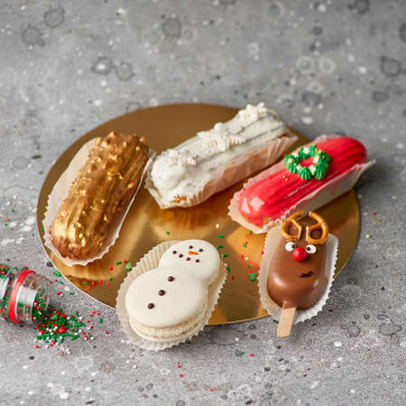 Banner for Christmas and New Years. sweet deer, eclairs, snowflakes, sweet snowman on a concrete...