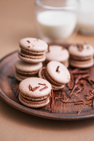 Chocolate macarons with chocolate filling. French meringue cookies macaron. copyspace. Morning Breakfast Cakesの写真素材
