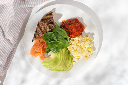 Omelette, scrambled eggs, with cucumbers, spinach and other healthy vegetables on white background,...