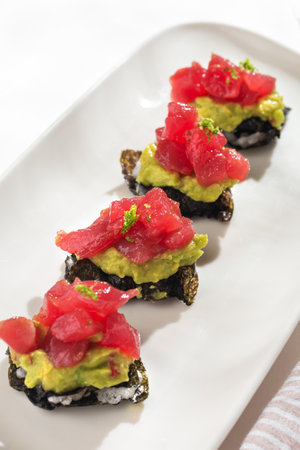 Appetizer Milfey tuna. Nori millefeuille, guacamole, tuna on white background for restaurant menu.の写真素材