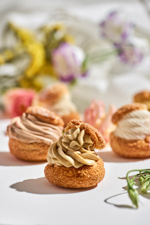 tasty cake shu or eclairs with cream on white background with copy space.の写真素材