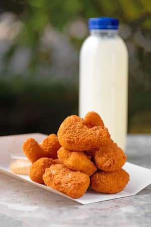 Tasty fried chicken nuggets, food delivery, takeaway food, on paper containers with nuggets and...