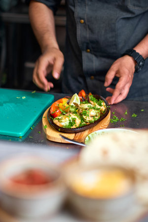 Traditional mexican beef fajitas on fire in the kitchen, kitchen cooking process.の写真素材