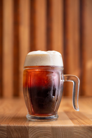Glass of fresh beer on a wooden table. Lager cold beer mug on table. copy space