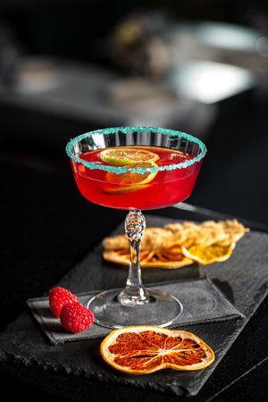 Rossini italian red alcoholic cocktail with sparkling wine, strawberry puree and ice in champagne glasses, copy spaceの写真素材