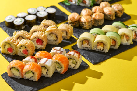 set of sushi roll different type on a yellow background. Top view. Traditional Asian foodの写真素材