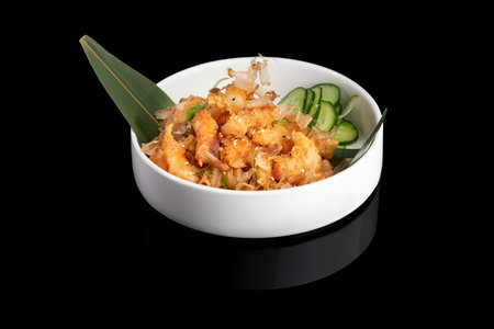 Fried shrimps on a plate with vegetables on a black background with reflection. menu restaurant.の写真素材