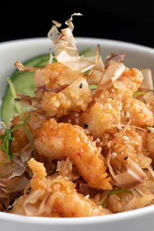 Fried shrimps on a plate with vegetables on a black background with reflection. menu restaurant.の写真素材