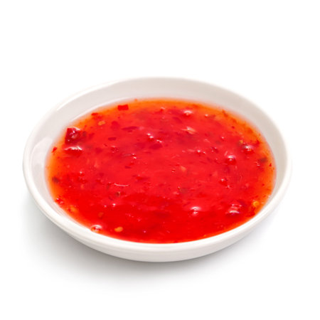 Sweet chilli sauce in a white ceramic bowl isolated on white. For the restaurant menu. Traditional Japanese sushi seasoning. healthy eatingの写真素材