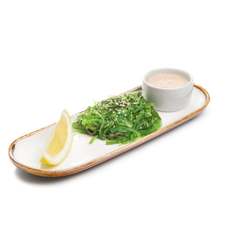 Chuka salad on a plate. Ingredients Marinated seaweed, peanut sauce, lemon, sesame mix. For restaurant menu.の写真素材