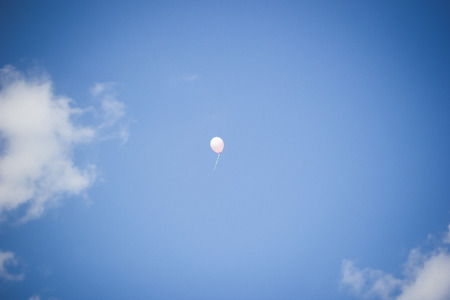 flying balloon in the blue skyの写真素材