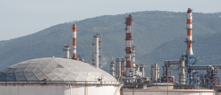Gas pipes and storage tanks on an oil refinery plantのeditorial素材