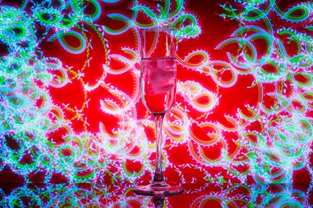 A glass of champagne with ice in the background of the fireworks.の写真素材