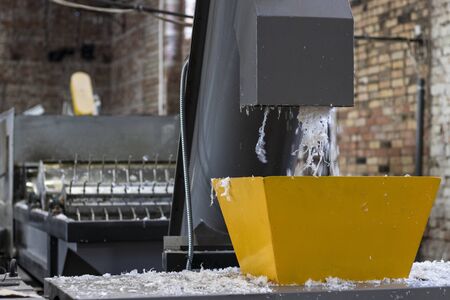 Peeled flakes of shredded plastic bags. The machine washes and cuts the plastic film for recyclingの写真素材