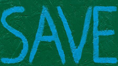 Blue lettering save on a green background. Font written with a brush on a wooden wall. Save the inscription of ecological meaningの写真素材