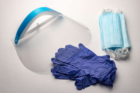 Personal protective equipment for medical workers. Reusable protective screen for the face. Disposable surgical gloves. Disposable medical face masksの写真素材
