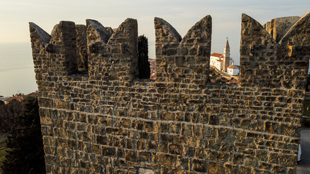 A view of a fortress and a nice mediterranean city at seaの写真素材