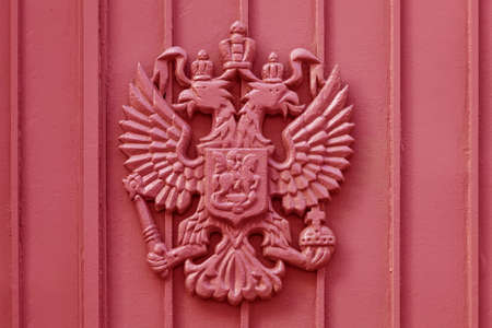 The coat of arms of the Russian Empire cast in metal painted redの写真素材