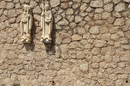 Fragment of the wall of a monastery in Spain with the image of a monk and nunの写真素材