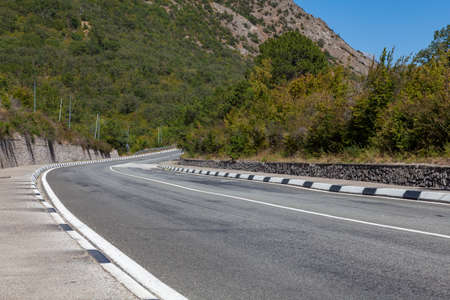 Asphalt winding motor road in the mountainsの写真素材