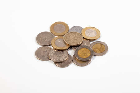 Heap of old coins of different countries on a white background