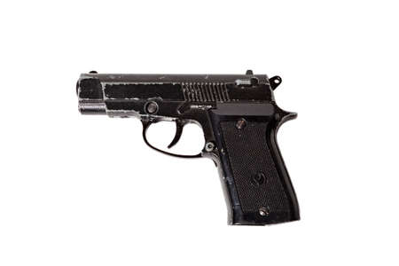 Black used pistol on white isolated background.