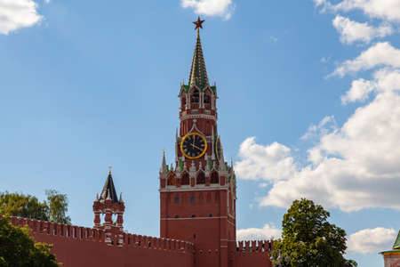 Spasskaya Tower of the Moscow Kremlin against the blue sky in white clouds.の写真素材