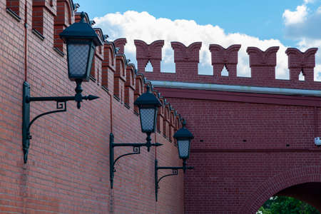 Three street lamps are attached to the wall of the Moscow Kremlin.の写真素材