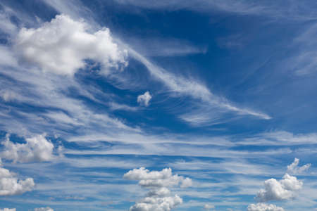 Background image - blue sky in light white clouds.