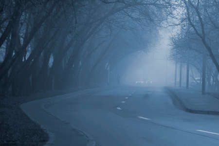 City street covered with thick fog. Toned photo.