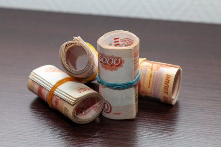 Rolled up five thousandth banknotes of Russian rubles lie on the table.の写真素材