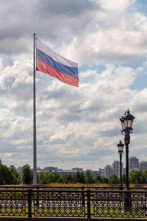 Large flag of Russia flutters in the wind in Victory Park in Moscow.の写真素材