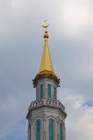 Minaret of the Moscow Cathedral Mosque against a cloudy sky.の写真素材