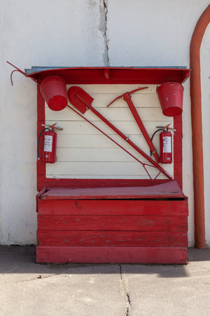 Old fire shield with a set of fire extinguishing tools.の写真素材