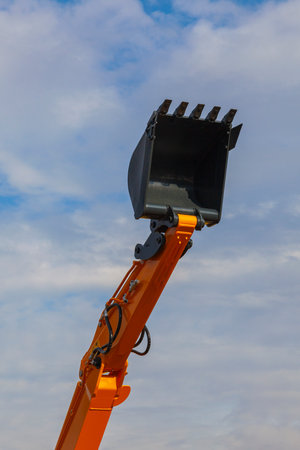 Extended lifting arm of an open bucket excavator.