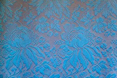 Fragment of an embroidered ornament of vintage wallpaper