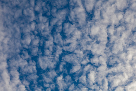 Texture of blue sky in light white clouds.