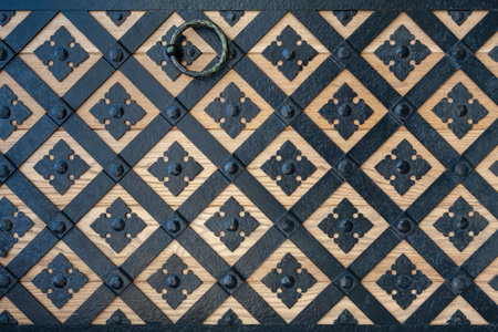 Background image - a fragment of a wooden gate covered with a wrought iron pattern.