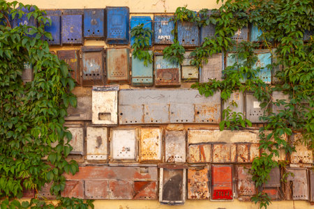 Various old mailboxes on the wall of a house. Some have the Russian inscription "Post Office" on them.の写真素材