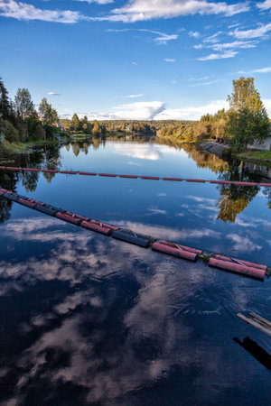 Floating Trash Barriers Crossing a River - Environmental Cleanup System.の写真素材