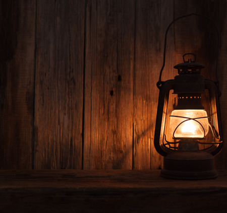 lantern lamp light dark wooden wall table backgroundの写真素材